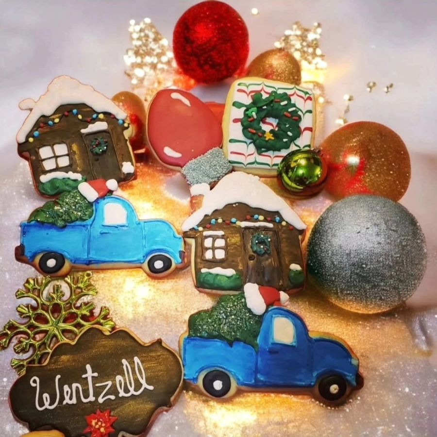 Christmas sugar cookies shaped like gingerbread houses and trucks with trees