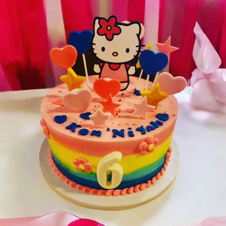 Rainbow Hello Kitty cake for a 6th birthday with hearts and stars