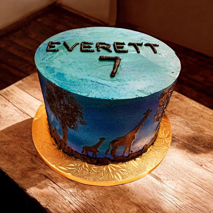 Blue twilight safari cake with giraffe silhouettes for a 7th birthday